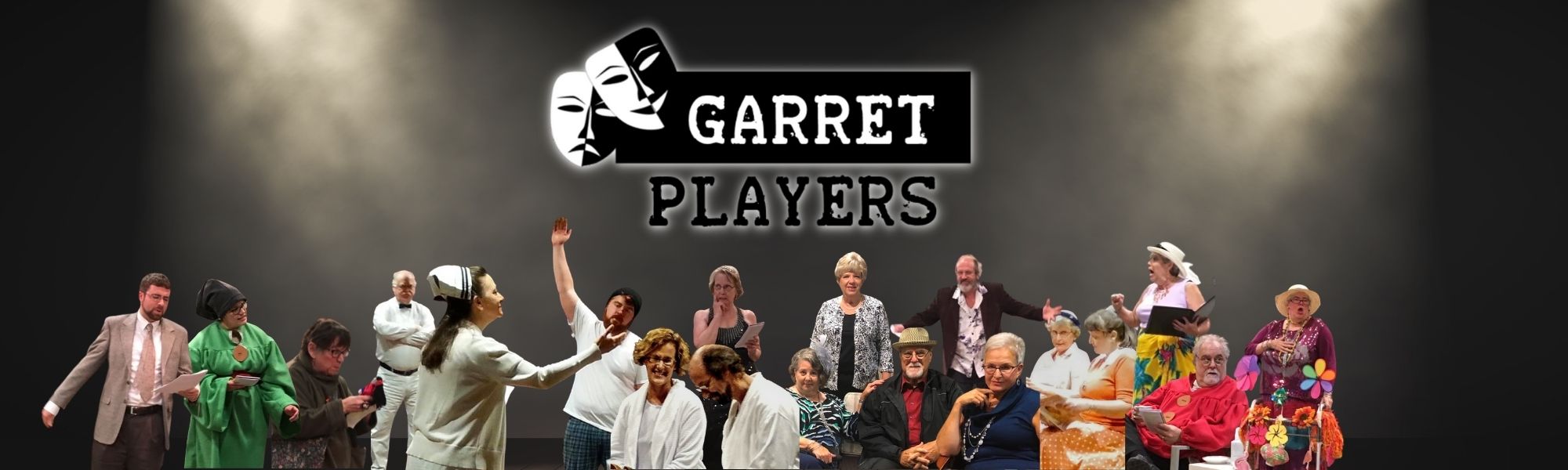 Garret Players cast members in costume on stage beneath the Garret Players logo
